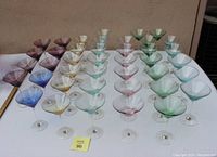 Front view of 40 colorful martini glasses arranged in rows showing variety of colors.