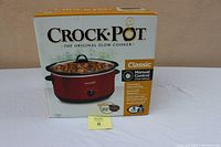 Front view of the boxed Crock-Pot slow cooker showing the product image, brand, capacity (6 quarts), and control type (manual).