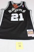 Front view of black Spurs youth basketball jersey number 21 with tags and logos visible.
