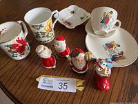 View of assorted Christmas mugs, salt and pepper shakers, candy dish, and Ceylon teacup and saucer showing designs and details.