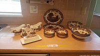 Full set of J & G Meakin England brown transferware ironstone china accessory pieces displayed on countertop.