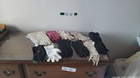All gloves laid flat on a table showing variety of colors and materials