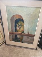Full view of the framed painting of the arched doorway with flowers and reflections in a neutral frame.
