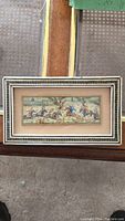 Full view of framed Persian hunting scene showing entire miniature painting and decorative frame.