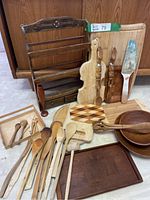 Full view of wooden kitchen items showing spice rack, cutting boards, spoons, bowls, and trays