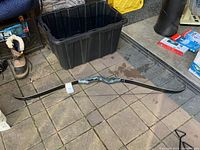 Full view of black hunter recurve bow showing entire length and slight curvature of limbs