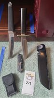 All items laid out: two fixed blade knives, folding knife, multi-tool, two sheaths
