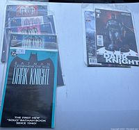 Wide photo showing all comics laid out in protective sleeves, highlighting the mix of 90s and newer Batman comic series.