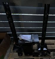 Overview of LG home theater system showing tall tower speakers, receiver, subwoofer, smaller speakers, remote, and cables arranged on wooden pallet.