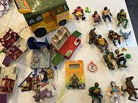 Full overview of the Ninja Turtle toys including the van, multiple figures, and playset furniture
