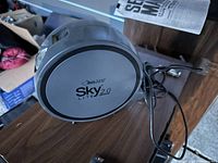 Black Light Sky Lite 2.0 galaxy light projector on a wooden surface with power cord visible.