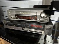 Photo of Sears VCR stacked on top of JVC CD player showing front panel and controls