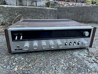 Front full view of the vintage Baycrest stereo receiver with wood side panels and multiple knobs and switches.