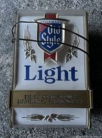 Front view of the vintage Heileman's Old Style beer bar light, showing logo, text, and mounting cord.