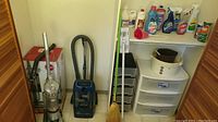 Overview photo showing Hoover upright vacuum, Kenmore canister vacuum, broom, cleaning supplies on shelves, and storage drawers.
