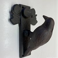 Front side angle view showing cast iron bird door knocker with leaf-shaped detail on backplate.