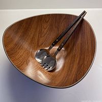 Triangular synthetic bowl with woodgrain teak finish and matched serving spoon and fork inside