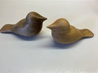 Pair of hand carved wooden birds shown together on flat surface, demonstrating size and condition with no glued seams.