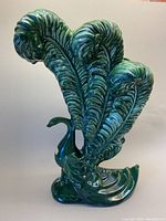 Front view of green Royal Haegar peacock vase showing elaborate tail feathers and glossy finish.