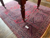 Full view of the rectangular woven rug under furniture showing overall geometric pattern