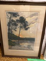 Photo showing the full framed art print depicting a landscape with sunset and trees