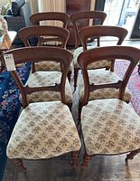 Front view of six matching dining chairs arranged in two rows