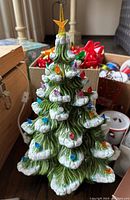 Ceramic Christmas tree with snow detail, multicolor bulbs, and top star