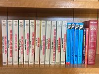 Books arranged on wooden shelf showing spines with titles from Great Illustrated Classics, Hardy Boys, and The Adventures of Tom Sawyer.