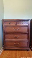 Front view of Kroehler 5 drawer wood dresser showing design details and condition.