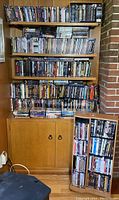 Full view of several shelves filled with DVDs and Blu-rays showing a large variety of titles and genres.
