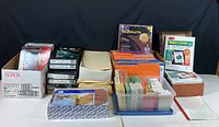 Full assortment of office file folders, report covers, alphabetical files, and plastic sheet protectors arranged on table showing all items included in the lot.