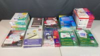 Wide view of all stationery items including boxes and packs for checks, labels, cards on table