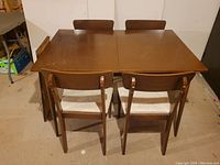 Full set of walnut table and four chairs seen from the back top view