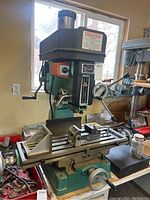 Front view of full milling/drilling machine on bench with vise attached