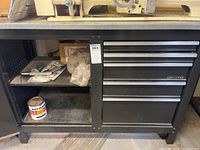 Wide view of the metal Craftsman workbench showing drawers and cabinet with contents