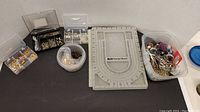 Lot overview showing all beads, fasteners, design board, foam and containers