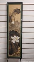 Full view of the framed Asian floral artwork showing brown leaves and white flowers in vertical orientation.