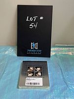 Front of black box labeled "Lot # 54" with logo and text "TheNextStep Forward"