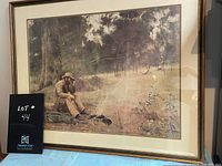Framed print of Fredrick McCubbin's painting showing a seated man outdoors with surrounding forest, vintage condition, gold-tone frame.