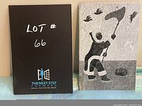 Photo showing entire stone panel with native carving, with a black sign displaying lot number