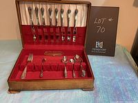 Full view of the silver plate cutlery set in the open original case showing knives in top section and other cutlery items below.