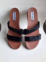 Top view of the Steve Madden black flat sandals showing the footbed and two black straps on both sandals.