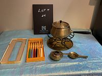 Full set overview including fondue pot, stand, burner, tray and forks in original packaging