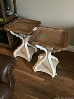 Pair of matching wood end tables with brown natural wood tops and white bases. Check overall look and condition.