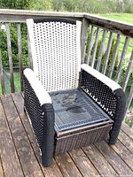 Front view of woven rope patio chair with black and white pattern, showing metal mesh base without cushion.
