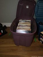 Plastic tote filled with vintage LP records shown from a distance
