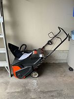 Side view showing handle, wheels and overall unit in garage