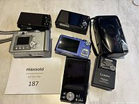 All cameras and accessories from front angle showing LCD screens and controls