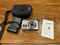 Camera front view showing lens, branding and megapixels