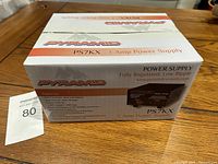 Photo of the box front and top showing the product name 'Pyramid PS7KX 5 Amp Power Supply' along with features and specifications.